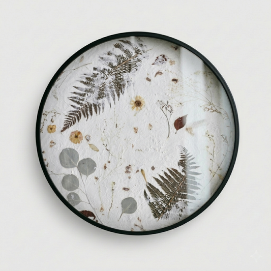 Joanna Jernajczyk for Nudiflorum R55/08 — circular botanical wall art with pressed ferns, eucalyptus, dried flowers and meadow botanicals on white textured ground, black metal frame, 55 cm