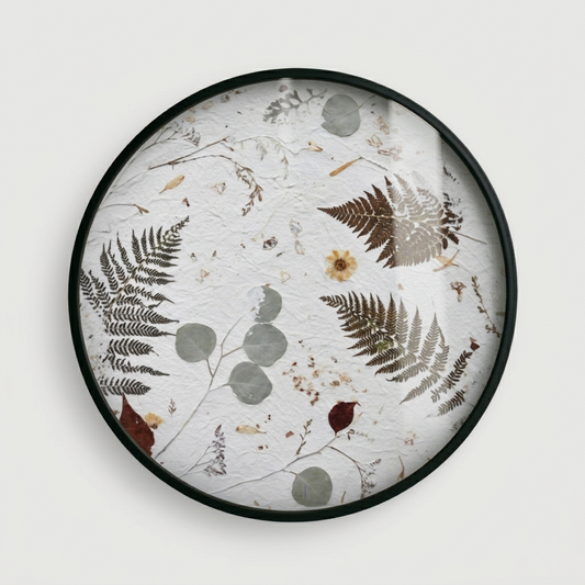 Joanna Jernajczyk for Nudiflorum R55/09 — circular botanical wall art with pressed ferns, eucalyptus, dried flowers and meadow botanicals on white textured ground, black metal frame, 55 cm