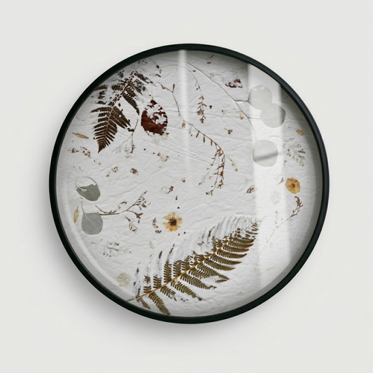Joanna Jernajczyk for Nudiflorum R55/02 — circular botanical wall art with pressed ferns in diagonal sweep, eucalyptus, dried yellow flowers and autumn leaves, black metal frame with glass, 55 cm